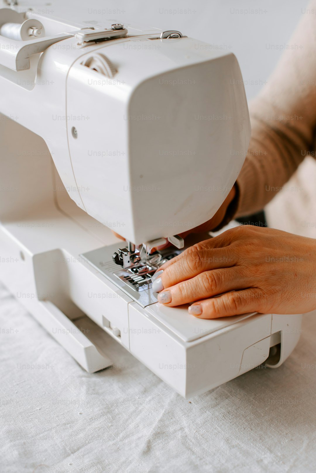 Tailor threading a needle